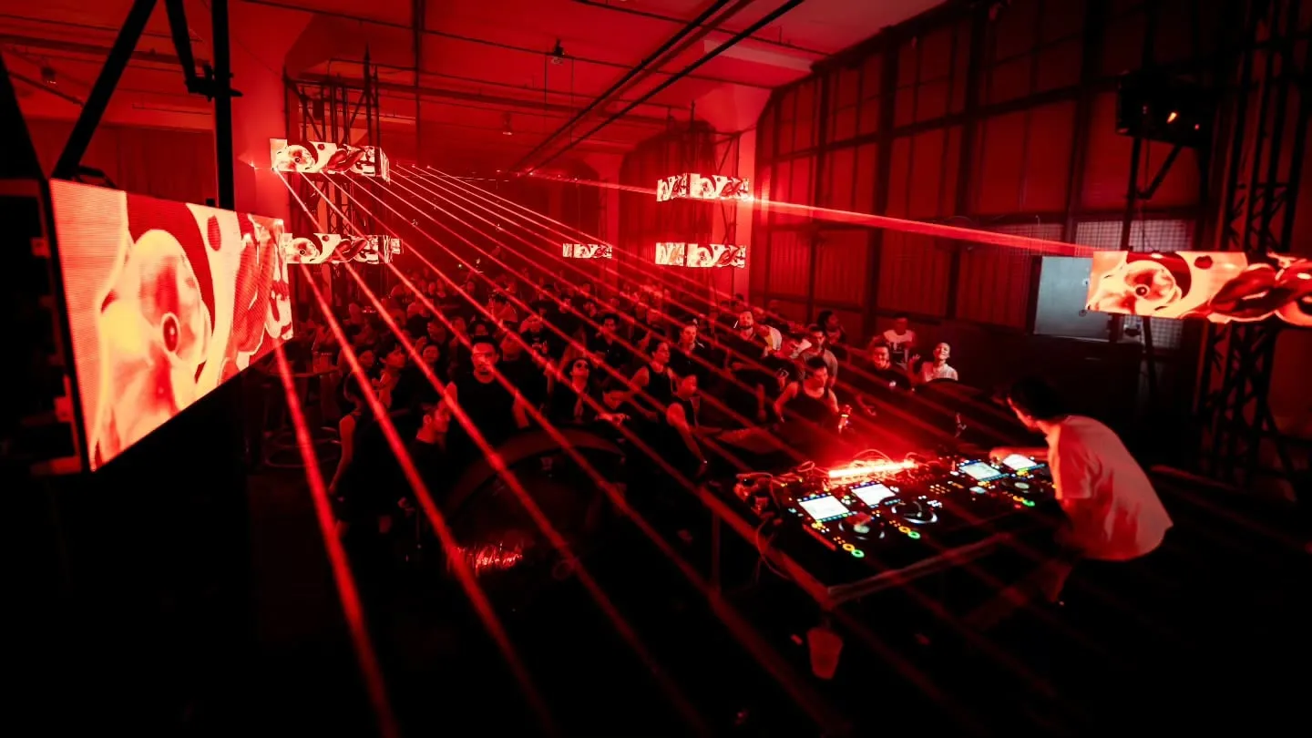 The DJ under the grid, LED panels either side of the room