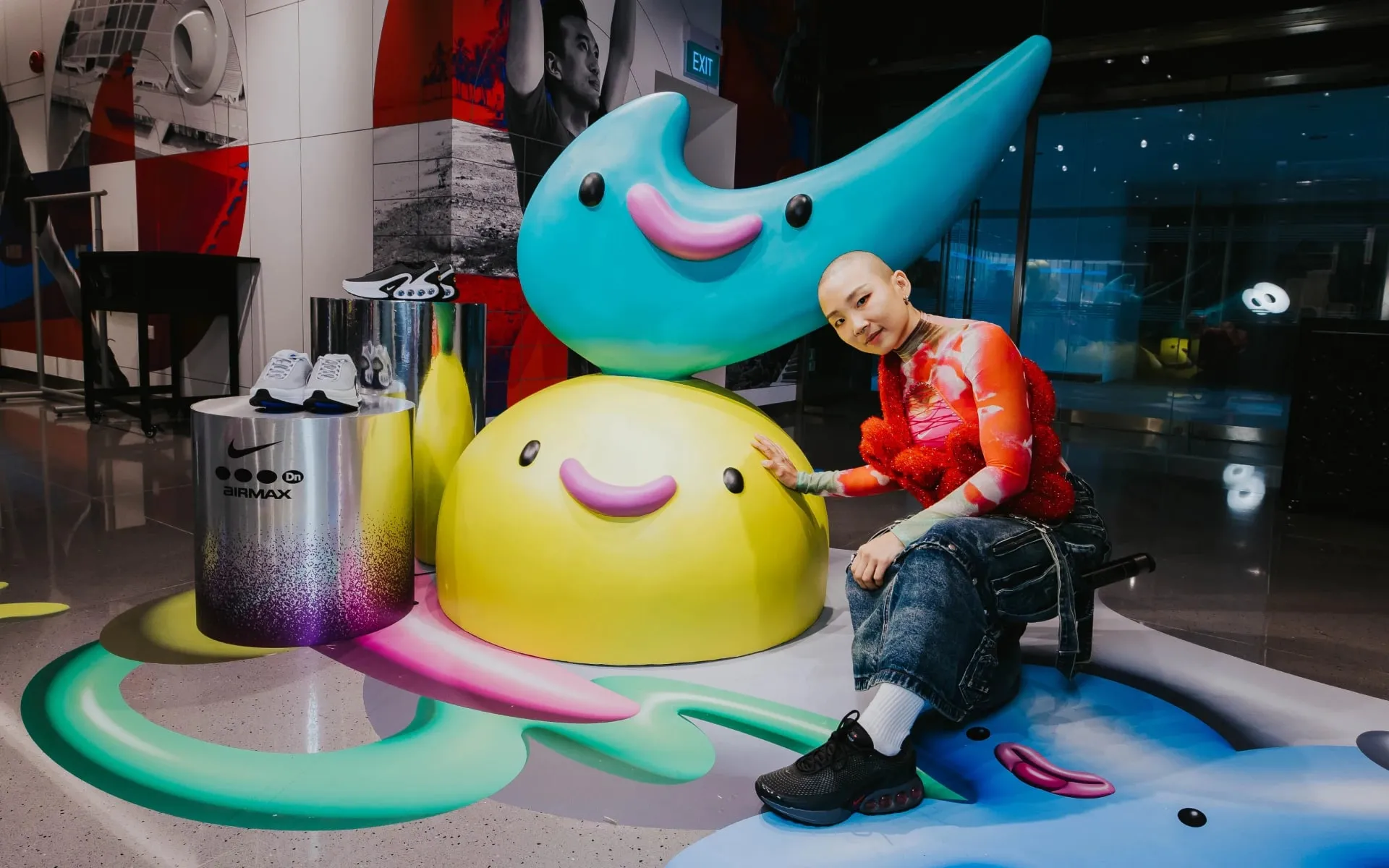 A guest with one of the characters at the store entrance