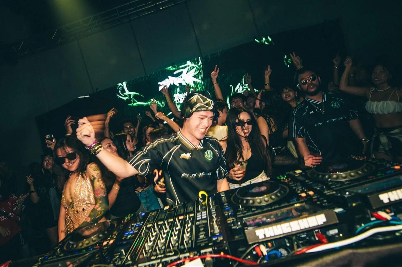 das_boyy in the booth, hands up behind him