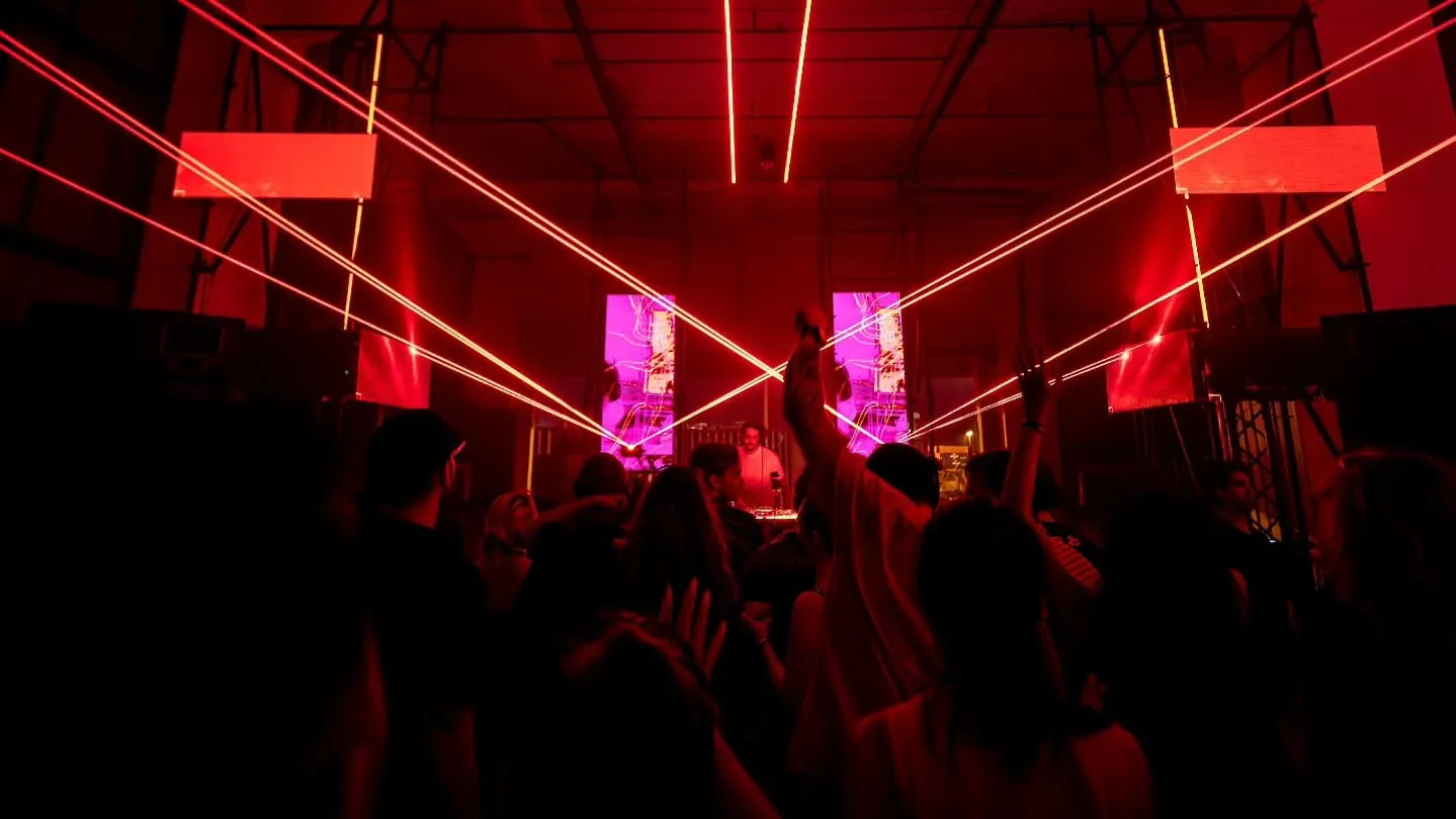 The floor, hands up, lasers converging overhead