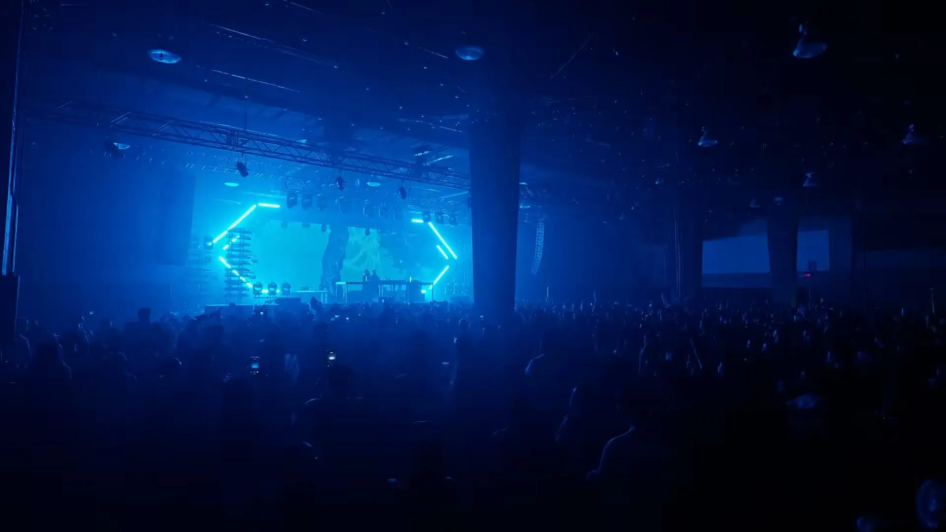 The whole hall in blue haze, the frame glowing at the far end