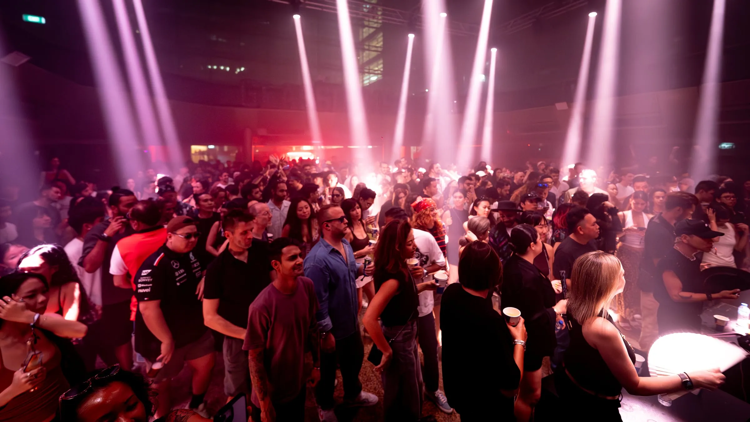 Beams and haze over the crowd late in the night