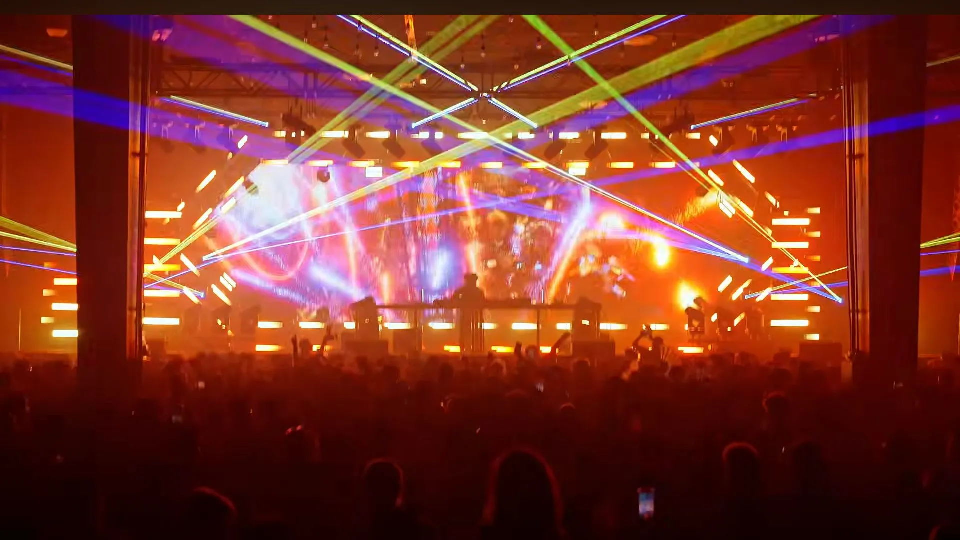 Orange lasers over the room from the back of the hall