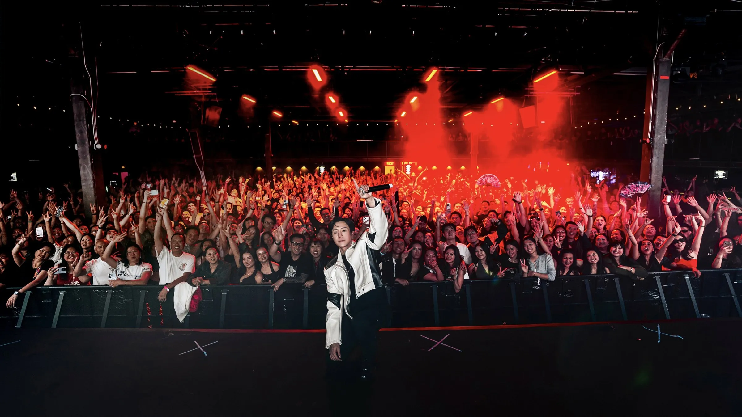 INQUISITIVE on the barrier with the crowd behind him, the room washed red
